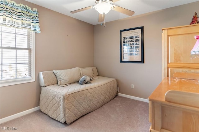 carpeted bedroom featuring multiple windows, baseboards, and ceiling fan