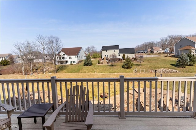 wooden terrace with a residential view and a lawn