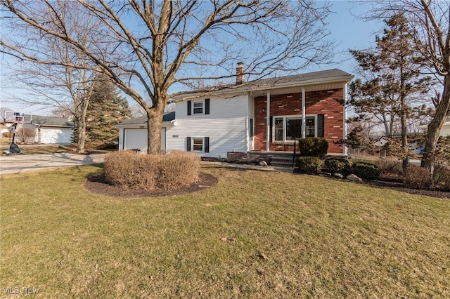 raised ranch with a front yard, brick siding, covered porch, and a chimney