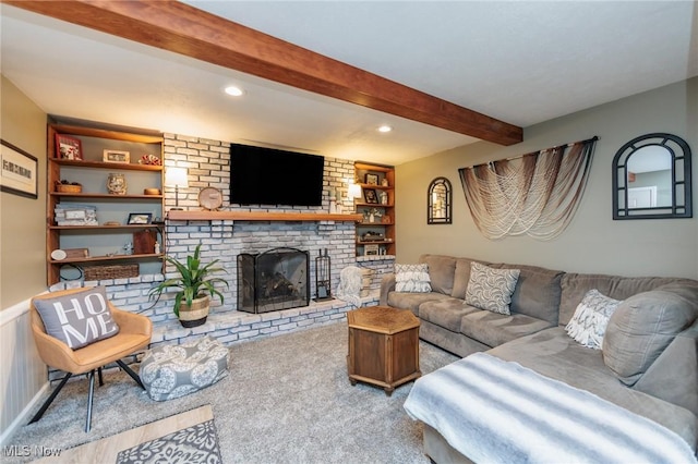 carpeted living room featuring recessed lighting, beam ceiling, built in features, and a fireplace