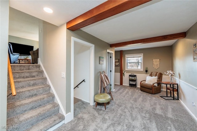 staircase with baseboards, beam ceiling, and carpet flooring