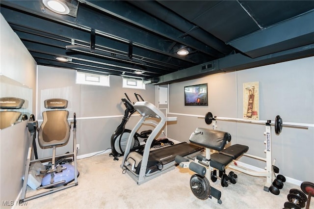 exercise room with carpet flooring, visible vents, and baseboards