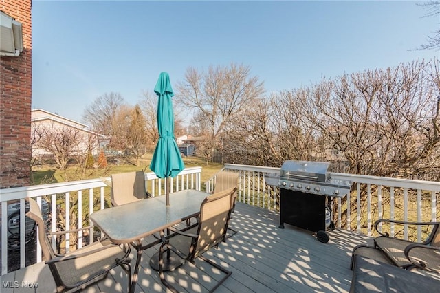 wooden deck featuring area for grilling and outdoor dining area