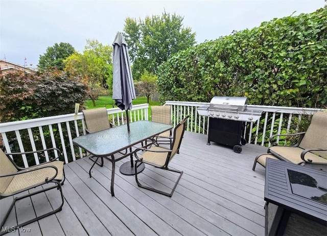 deck featuring area for grilling and outdoor dining area