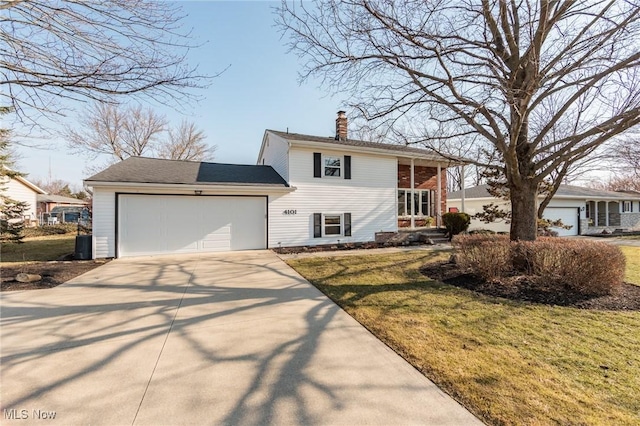 view of front of property featuring an attached garage, a chimney, a front yard, and concrete driveway