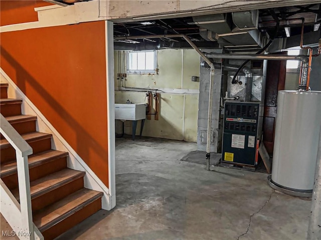 basement with water heater, stairs, and a sink