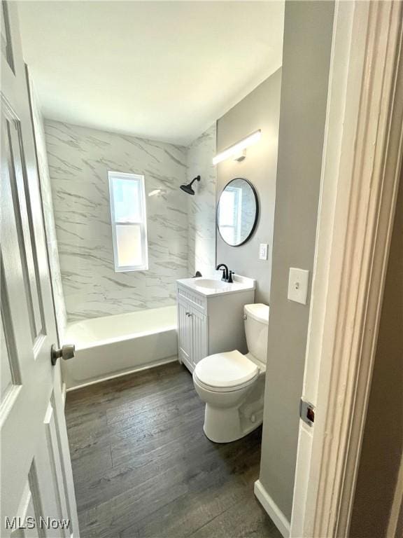 bathroom with vanity, toilet, bathing tub / shower combination, and wood finished floors