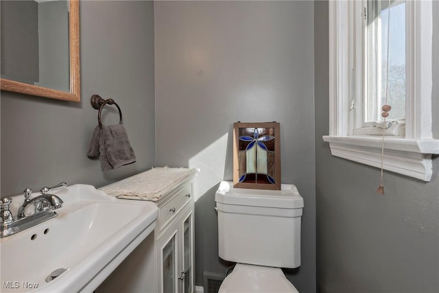 half bath with a sink and toilet