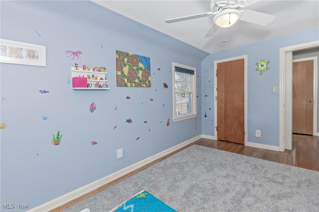 bedroom featuring ceiling fan, baseboards, and wood finished floors