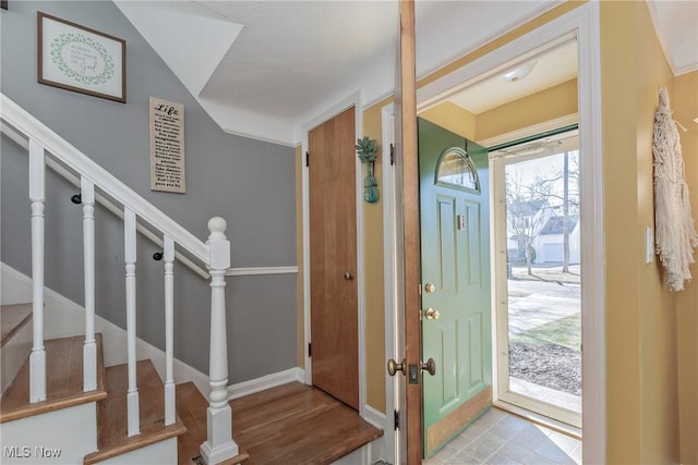 entryway with stairs and baseboards