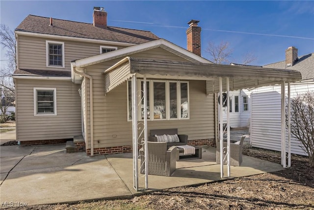 back of property with an outdoor hangout area, a patio, and roof with shingles