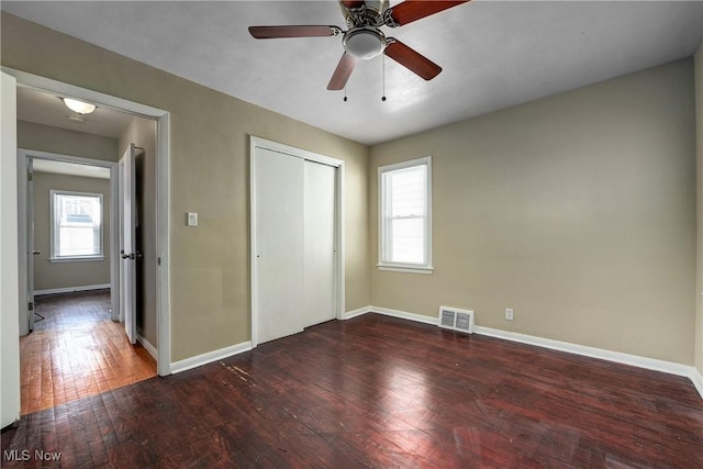 unfurnished bedroom featuring visible vents, baseboards, and hardwood / wood-style floors