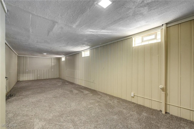 basement with a textured ceiling and carpet flooring