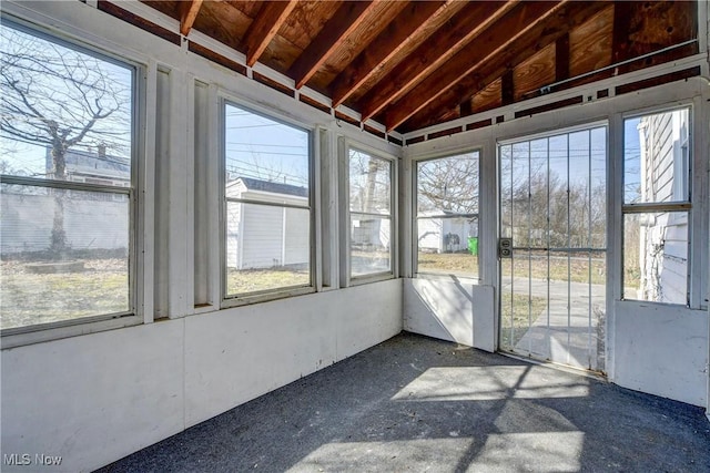 unfurnished sunroom with lofted ceiling