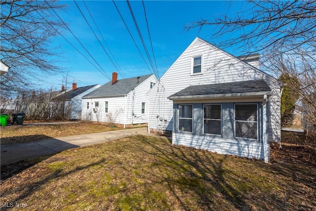 rear view of house with a yard