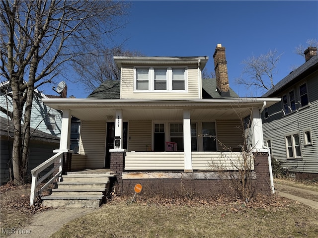 bungalow-style home featuring a porch and a chimney