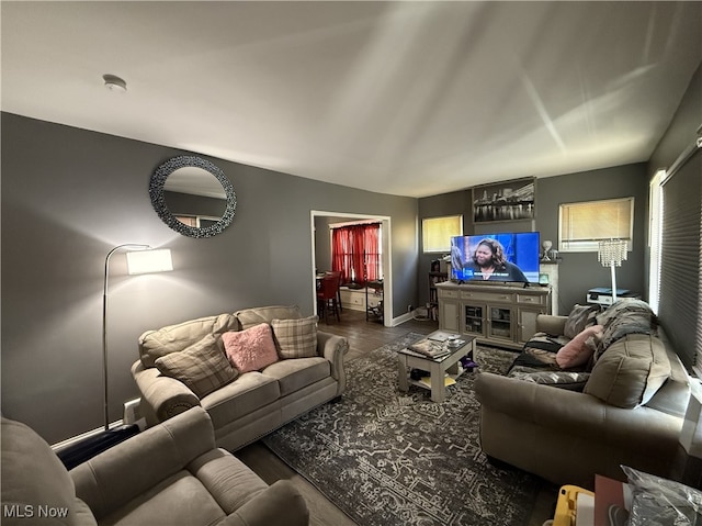 living room with baseboards and wood finished floors