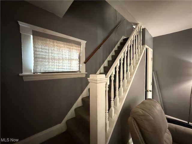 stairway featuring baseboards