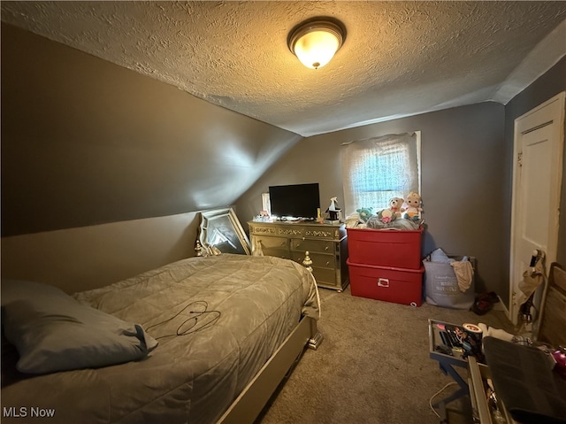 carpeted bedroom featuring vaulted ceiling and a textured ceiling