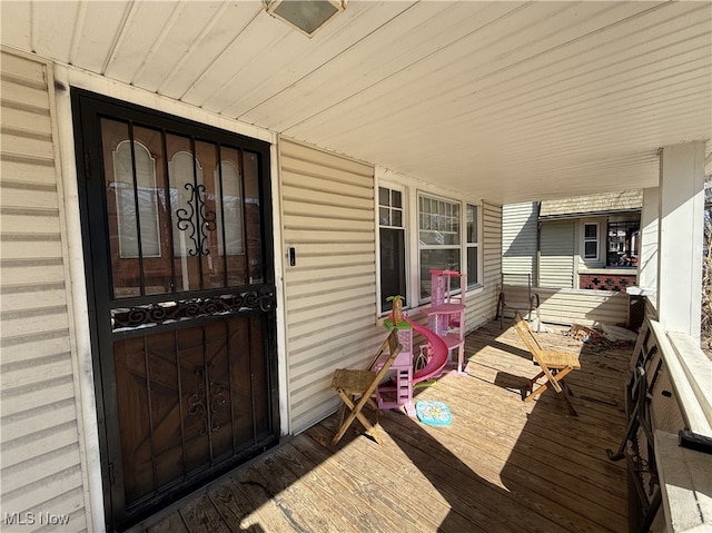 view of exterior entry featuring a porch