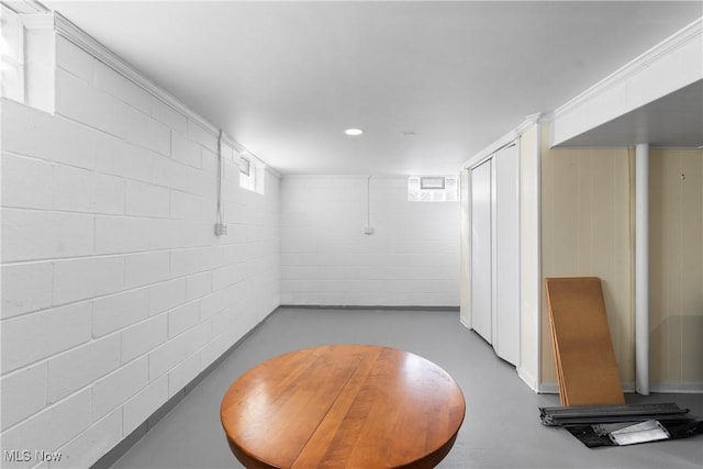 interior space featuring concrete block wall and recessed lighting