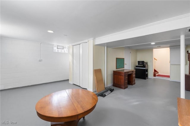 finished basement featuring stairway and recessed lighting