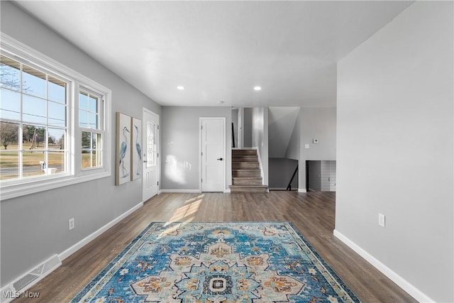 interior space with wood finished floors, visible vents, and baseboards