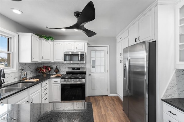 kitchen featuring a sink, stainless steel appliances, and white cabinets