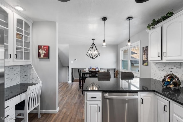 kitchen featuring tasteful backsplash, glass insert cabinets, stainless steel dishwasher, white cabinets, and dark wood-style flooring