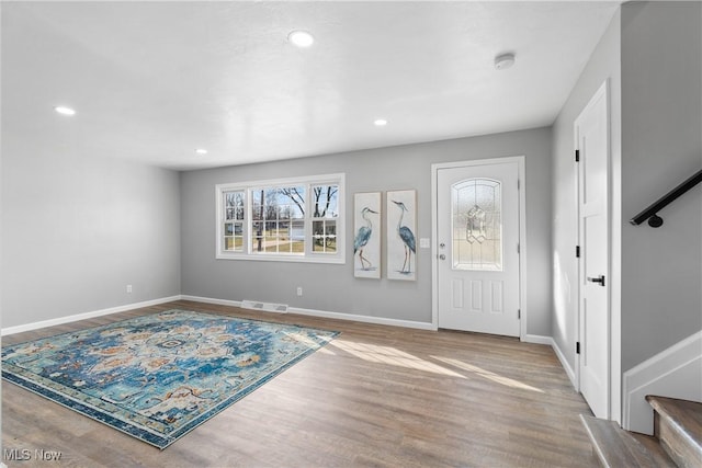 entrance foyer featuring visible vents, wood finished floors, recessed lighting, baseboards, and stairs