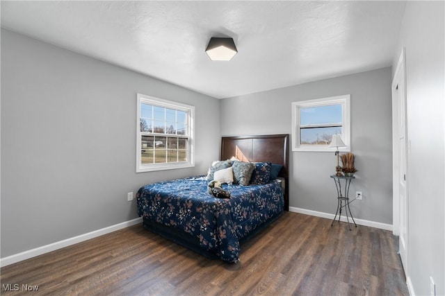 bedroom featuring baseboards and wood finished floors