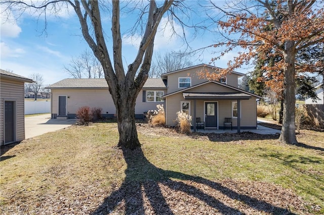 back of house featuring a yard, a patio, and fence