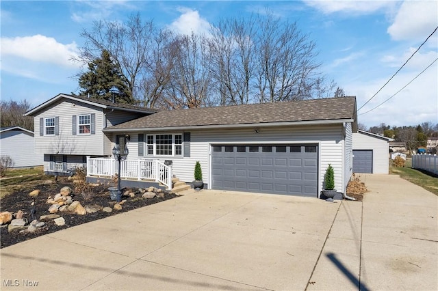 split level home featuring roof with shingles