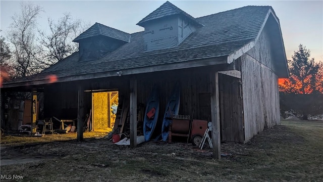 rear view of house featuring an outbuilding