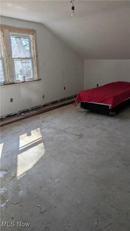 unfurnished bedroom with vaulted ceiling