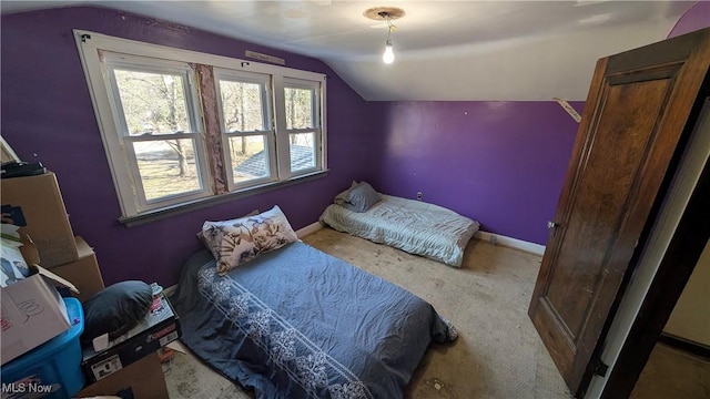 bedroom with baseboards and vaulted ceiling