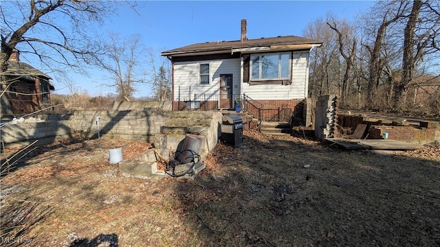 back of house with fence