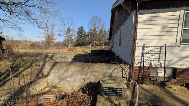 view of side of home with central AC unit