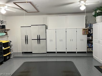 garage with a ceiling fan and white refrigerator