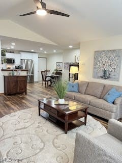 living room with ceiling fan, wood finished floors, recessed lighting, and vaulted ceiling