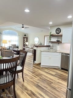 kitchen with a ceiling fan, open shelves, stainless steel dishwasher, white cabinetry, and light wood finished floors