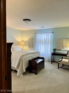 bedroom featuring light colored carpet