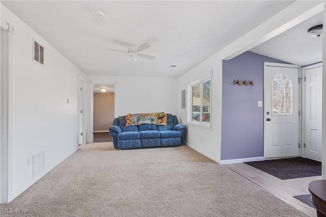 living area featuring visible vents, carpet floors, baseboards, and a ceiling fan