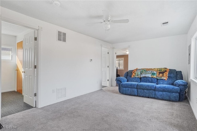 living area with visible vents and carpet floors