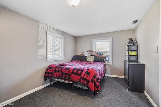 bedroom with visible vents, baseboards, and dark colored carpet