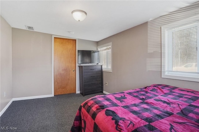 carpeted bedroom with baseboards, multiple windows, and visible vents