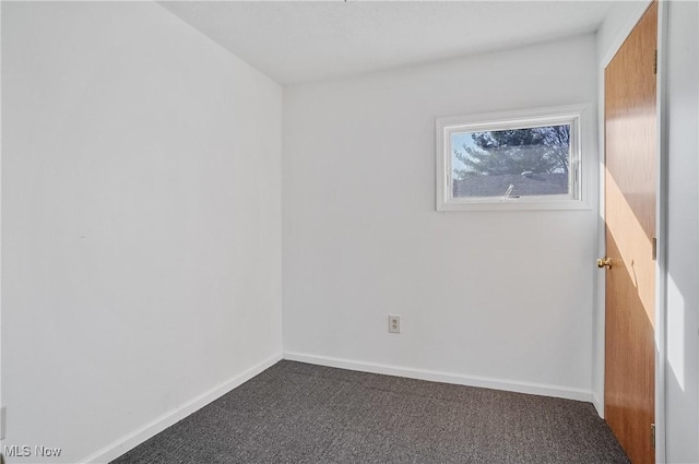 empty room featuring baseboards and carpet floors