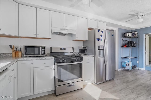 kitchen featuring under cabinet range hood, stainless steel appliances, light wood-style floors, white cabinets, and ceiling fan