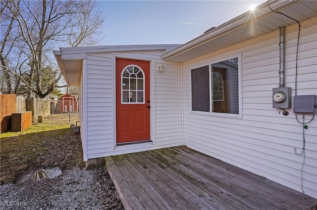 doorway to property featuring a deck and fence