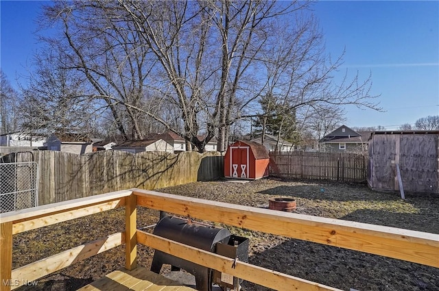 view of yard with a storage unit, an outbuilding, and a fenced backyard